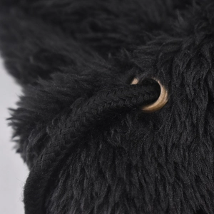 Detail of black fuzzy hooded beanie featuring metallic eyelet and woven drawstring