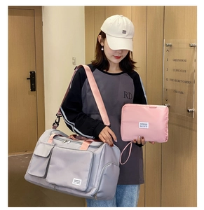Multi-functional fitness travel bag in dark grey with pink straps and small pouch
