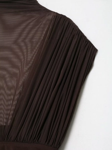 Macro detail of dark brown sheer mesh fabric with fine pleated textures on dress