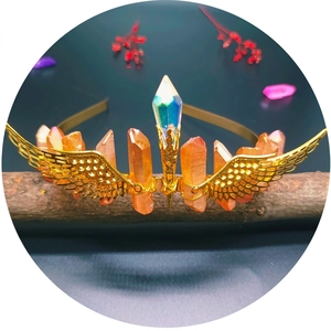 Handmade golden wing crown with orange natural crystal quartz on a rustic branch