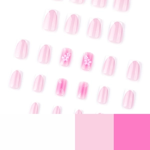 French tip press-on nails with pink floral accents and white polka dots on square tips
