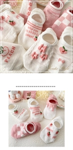 Close-up of pink and white mesh boat socks with peach embroidery and floral knit details