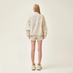 Rear view of cream jogging shorts and jacket set showing soft texture and relaxed fit