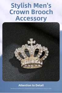 Close-up of a gold-plated crown brooch for men featuring sparkling white crystals and cross