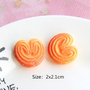 Close-up of heart shaped resin palmier miniature cookies on a plate for DIY crafts