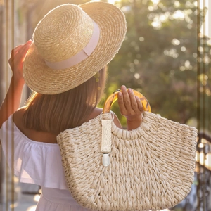 Close-up of beige crochet travel hat clip with silver metal ring on a woman outdoors