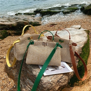 Detailed straw woven handbag showing metal twist-lock and fine craftsmanship in three colors