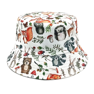 Close-up of printed forest animals pattern on white cotton sun bucket hat