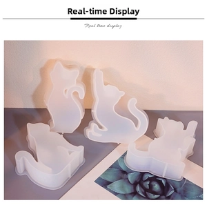 Detailed view of four assorted cat-shaped silicone molds for DIY resin and candle crafts