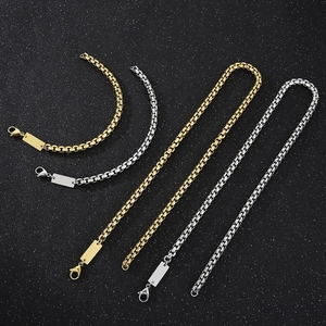 Detailed macro view of gold and silver square box chains with rectangular ID tags and clasps