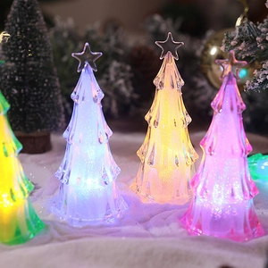 Close-up of mini acrylic LED Christmas tree night lights with colorful glowing effects