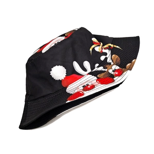 Detail of Christmas bucket hat fabric with Santa Claus and reindeer cartoon patterns