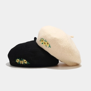 Wool beret for women with sunflower embroidery in black and cream white colors