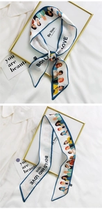 Close-up of elegant French style white twilly scarf with blue borders and chic illustrations