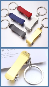Macro view of metallic mini scooter keychains in various polished mirror finishes