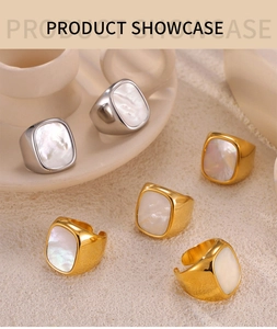 Detail of square gold and silver rings featuring elegant white mother of pearl inlay