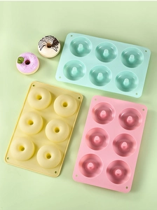 Detailed overhead view of 6-cavity silicone donut molds in macaron blue, yellow and pink