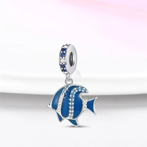 Detailed view of silver fish charm with blue enamel coating and sparkling zircons
