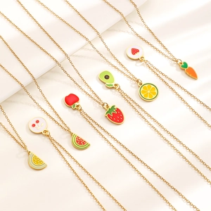 Macro view of colorful fruit enamel charms on gold stainless steel pendant necklaces