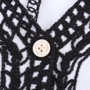 Ethnic style black crochet vest with hollow knit pattern and white button detail