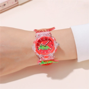 Close-up of kids' dinosaur watch with red rubber strap and 3D cartoon dinosaur details