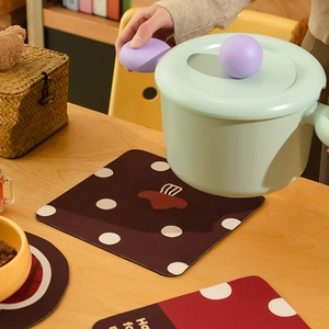 Mushroom patterned absorbent diatomite heat-resistant coasters on a rustic wooden table