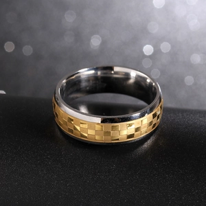 Macro detail of 6mm two-tone titanium ring with textured checkered pattern on dark surface