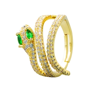 Gold snake ring with green zircon eyes and crystal wrap design on white background
