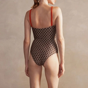 Polka dot one-piece swimsuit with orange straps and open back design for women
