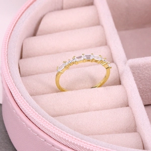 Close-up of luxury gold full diamond ring set inside a pink velvet jewelry box