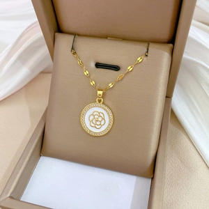 Detailed close-up of a golden camellia flower necklace pendant with white zircon micro-inlay