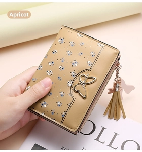 Detail of apricot floral PU leather wallet with gold butterfly buckle and tassel zipper