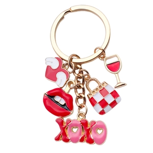 Gold-plated keychain with red lips, XOXO charm, wine glass, and checkered bag pendant