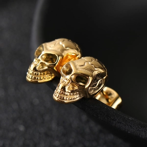 Gothic punk style gold skull earrings for men in polished stainless steel texture