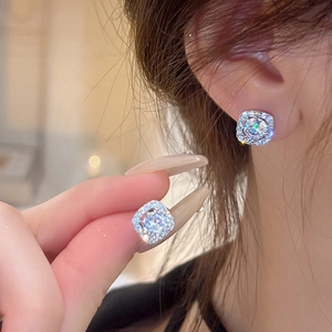 Detailed view of model wearing a silver halo square stud earring with sparkling crystals