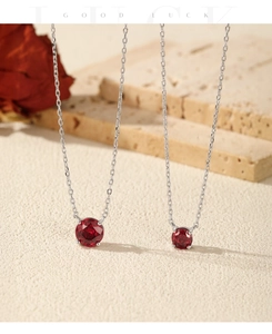Close-up of S925 silver necklaces featuring round pomegranate red rose cut gemstones