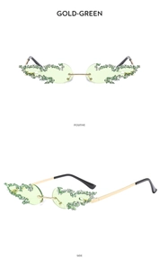 Detail view of gold-green rimless flame sunglasses with sparkling green rhinestones