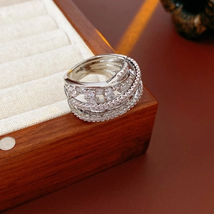 Macro shot of silver multilayer crisscross ring with zircons on a jewelry box