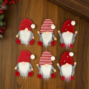 Detail view of 6-piece Christmas gnome cutlery holders on dark wood tabletop