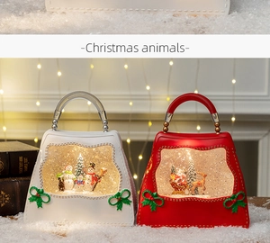 Close-up of Christmas handbag water lanterns with LED snowman and Santa scenes