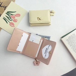 Short tri-fold PU leather wallet with bow charm in cream and dusty pink colors