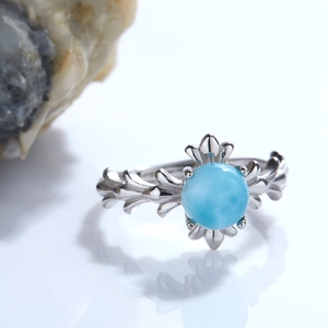 Macro shot of S925 sterling silver ring with floral details and blue gemstone