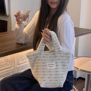 Close-up of white plush tote bag with colorful texture and sozakka beauté label