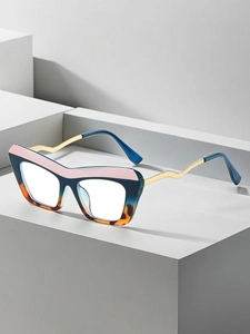 Detailed side view of cat-eye frames with wavy gold metal temples on grey steps