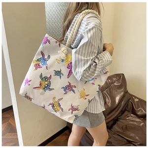 Canvas tote bag with colorful sea turtle print and durable thick rope handles on shoulder
