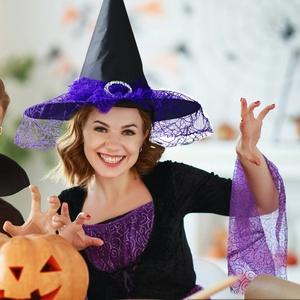 Detail of a black witch hat featuring purple lace trim and sequin mesh for Halloween