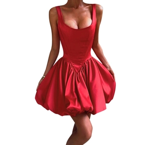 Detail view of red satin cocktail dress with fitted waist and puffed skirt on white backdrop