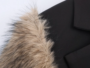 Detail of black fabric with light brown faux fur collar texture and high-quality stitching