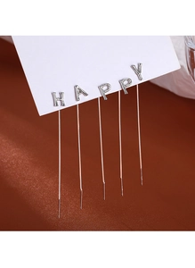 Close-up of silver-tone metal ear threads spelling HAPPY on a white display card