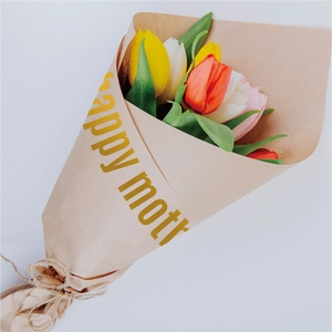 Detail of multi-color tulips in brown kraft paper with a 'Happy Mother's Day' gold sticker